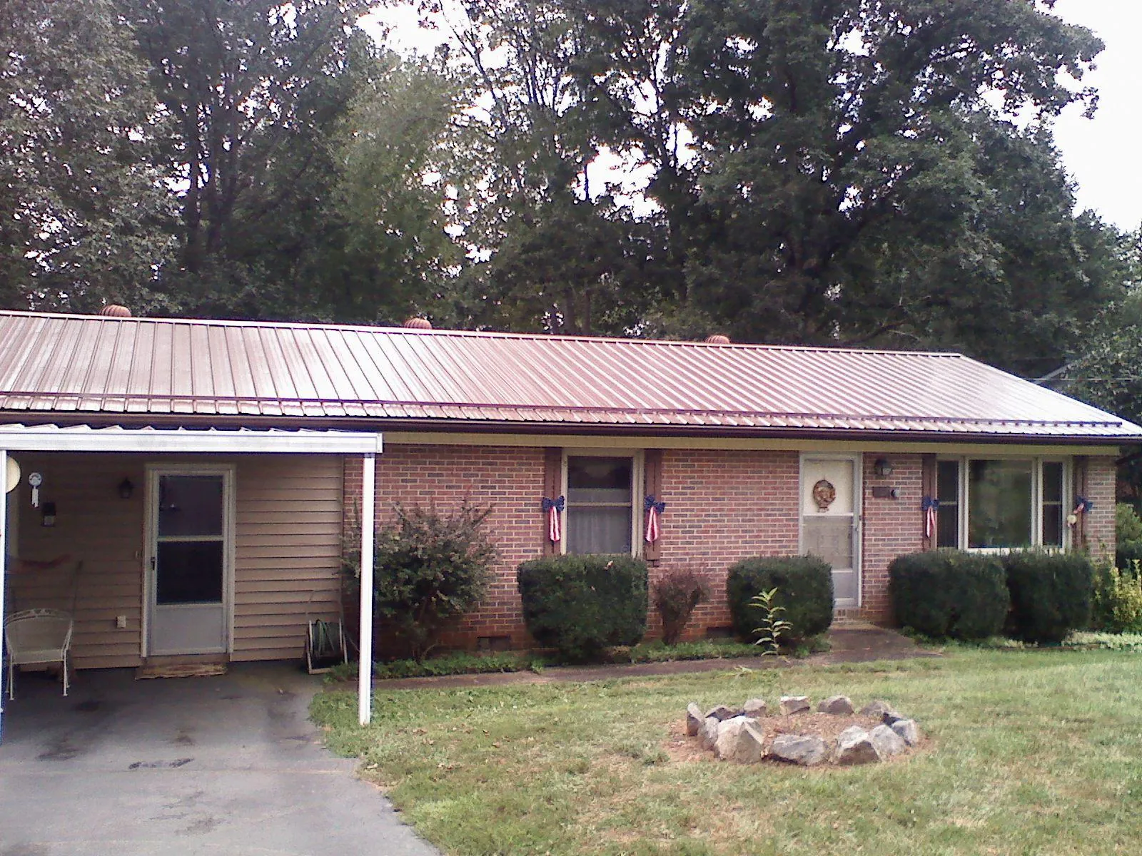 Bronze metal roof and carport on a brick ranch home — Roof Repair work by our crew in Cloverdale